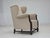 1960s, Danish wingback armchair. Original light beige furniture velour, carved oak wood, brass springs in the seat....