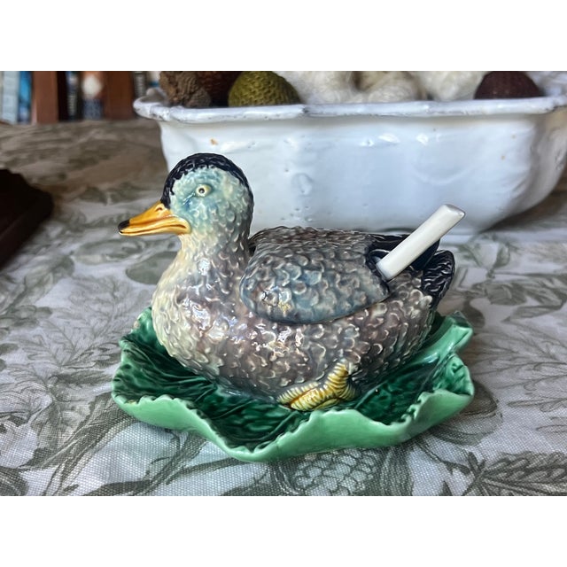 Bordallo Pinhiero figural lidded duck floating on a leaf, includes a lid and spoon. Made in Portugal in the late 20th...