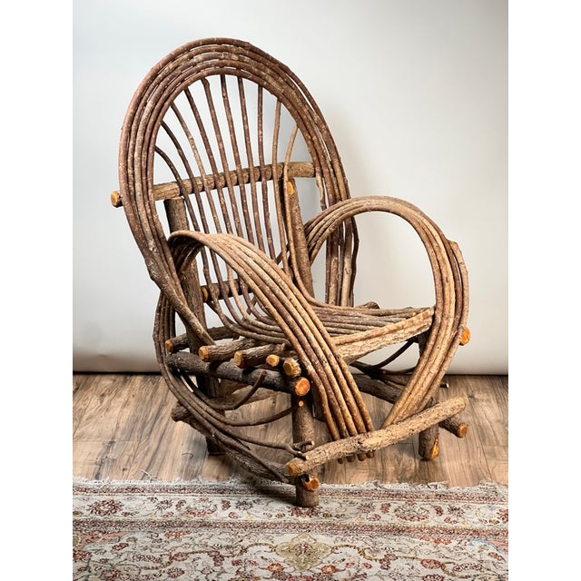 This wonderfully sculptural vintage bent willow arm chair captures the rustic charm and handcrafted character long...