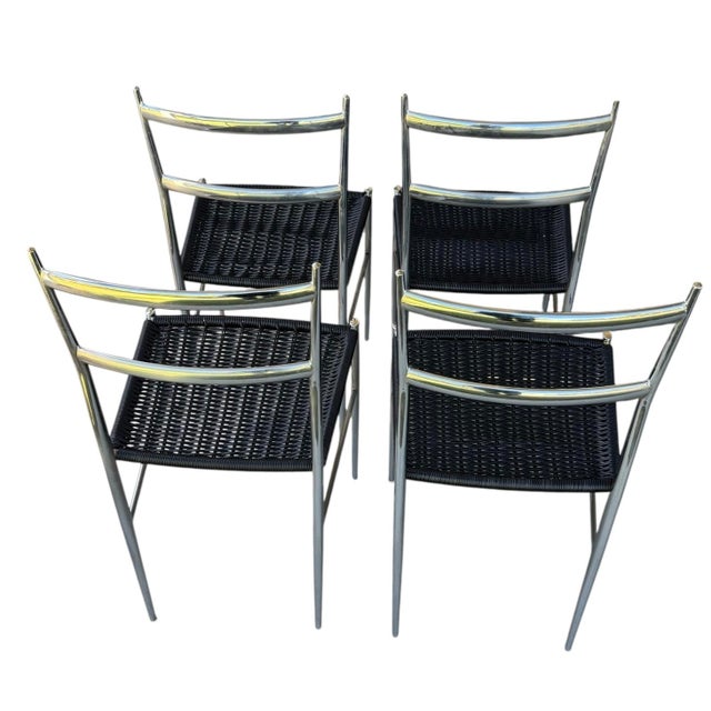 A set of four Italian Superleggera chrome chairs with woven black plastic seats attributed to Gio Ponti.