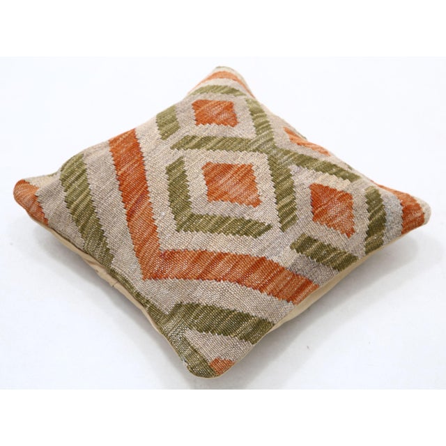 A one-of-a-kind handwoven Afghan wool kilim accent pillow featuring concentric diamond in terracotta and olive. Cut and...