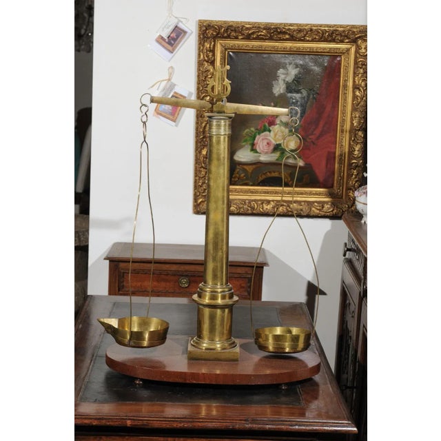 An English brass herbalist scale from the 19th century, with column and lyre details, mounted on a wooden base. Used to...