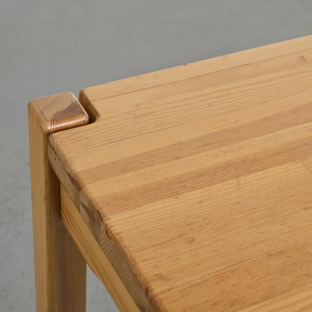 A set comprising a table and two benches in solid pine, made in France around 1980, in the style of Éditions Regain. The...