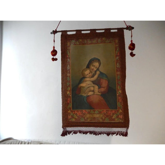 Beautiful oliograph of Mary and Jesus. Flowers on border. On bottom reads "Ave Maria". Embroidery still in great shape...