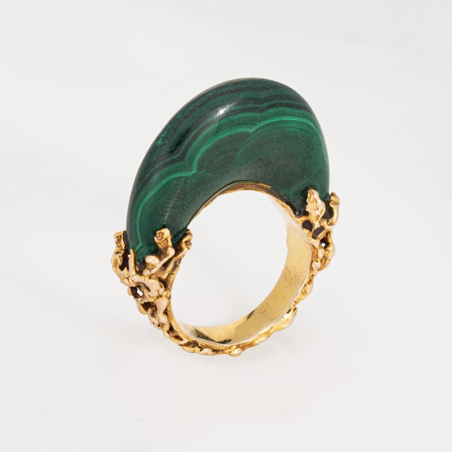 Distinct and elaborate vintage malachite ring (circa 1970s) crafted in 14 karat yellow gold. Malachite measures 23.5mm x...