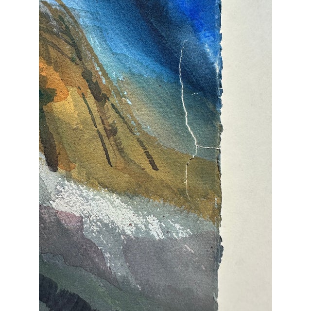 A dynamic watercolor painting of a dramatic cliff in a mountain range, set against a cobalt sky, with a building, some...