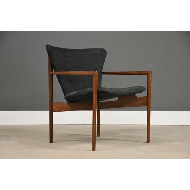 A mid century modern, rare form, dark charcoal grey leather lounge chair made with a solid walnut frame. Circa 1950’s....