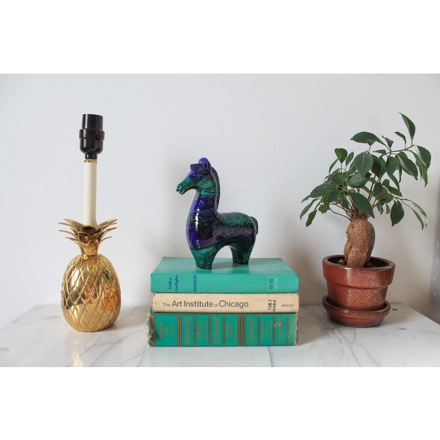 Vintage brass pineapple table lamp. Wired and in working condition. Uses standard 60 watt bulb. No makers mark. Neck of...