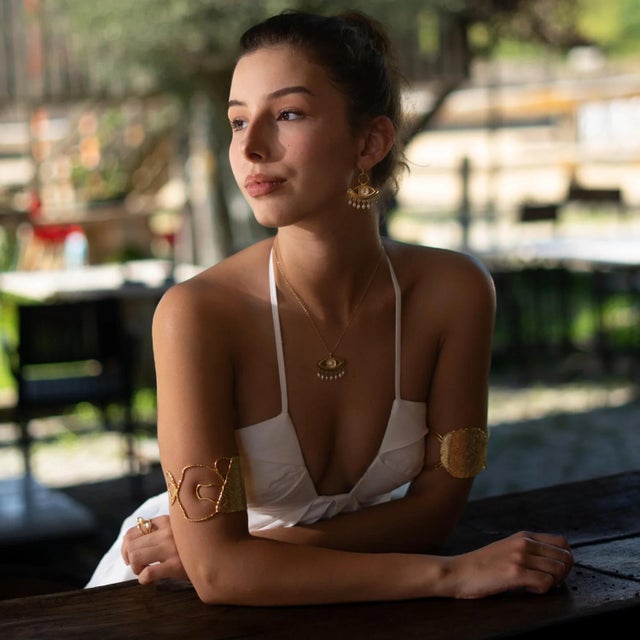 Bring timeless elegance and spiritual protection together with the Pearl Vision Evil Eye Gold Dangle Earrings. Crafted...