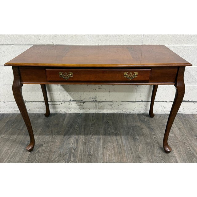 This is a gorgeous and classic vintage Queen Anne style writing desk crafted in a warm cherry finish with elegant cabriole...