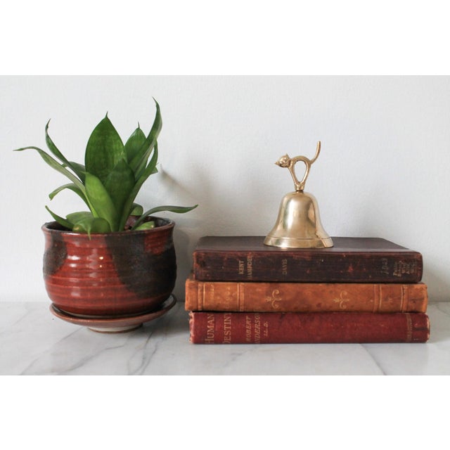Mid-century polished brass arching cat dinner bell. No makers mark. Minor age wear.
