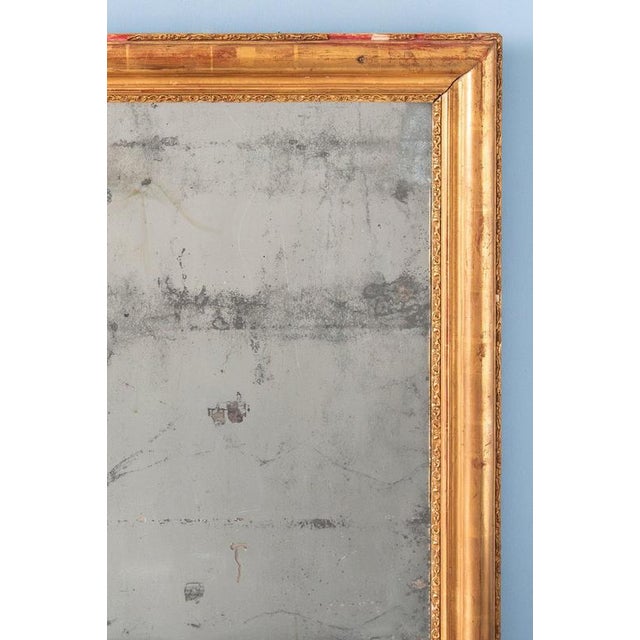 Height: 66.5 cm Width: 57 cm Minor losses to the frieze. Gentle wear to the silvered mirror plate.