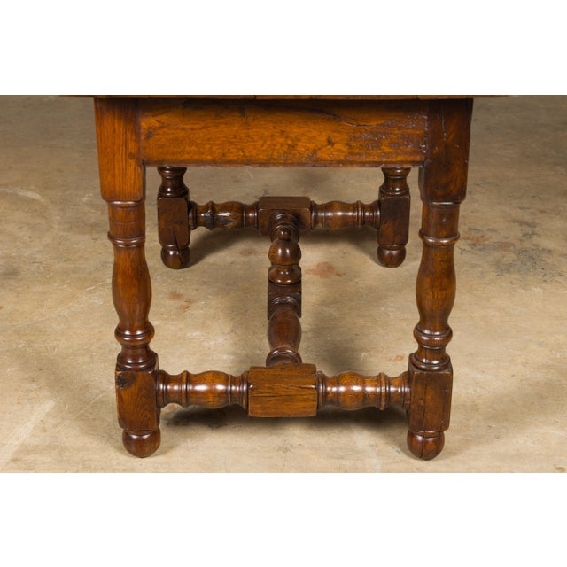 An English oak side table from the 18th century with single drawer, turned base and H-Form cross stretcher with carved...