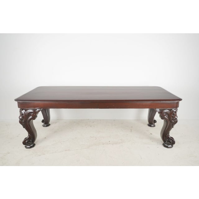 Chippendale style sofa accent table made of dark stained wood with piano cabriole legs. On the corners, it features...