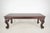 Chippendale style sofa accent table made of dark stained wood with piano cabriole legs. On the corners, it features...