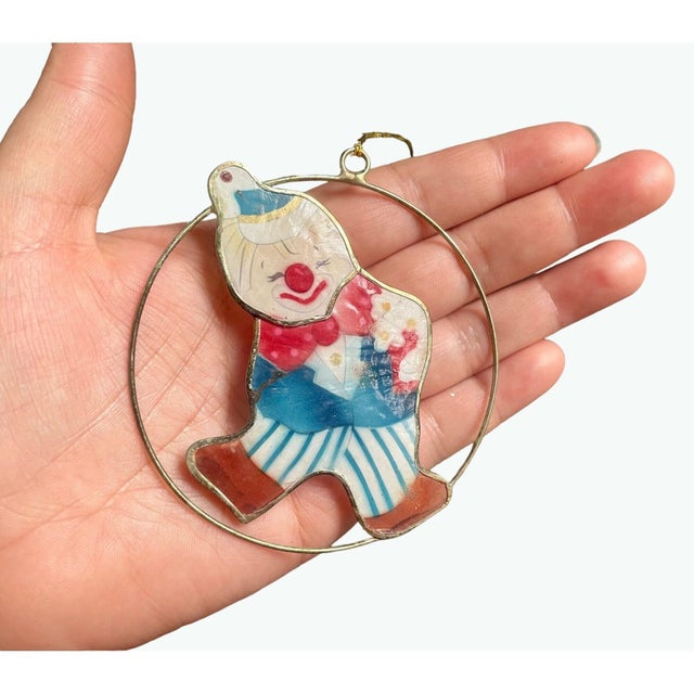 Add a touch of whimsy and vintage charm with this rare clown ornament crafted in mother-of-pearl. This unique piece...