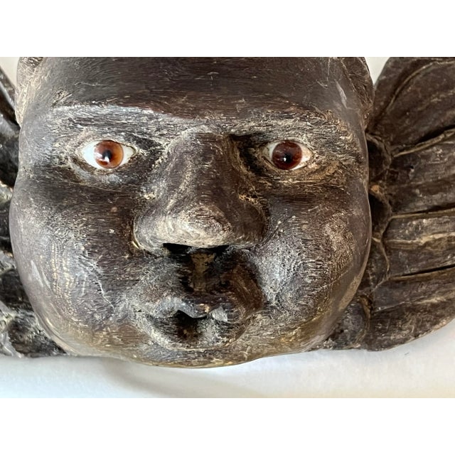 Spanish Colonial Style immortal angel. The angel has a wonderful curl on the top of his head and brown glass eyes....