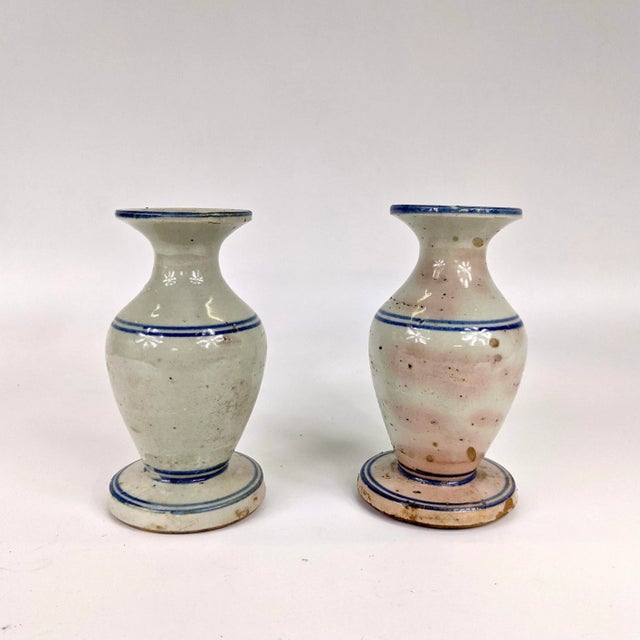 A beautiful blue and white ceramic candle stick holders from the 18th century. One side has pink pigmentation.