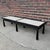 Beautiful black lacquered wood coffee table with inset terrazzo panels on the top. The brass caps on the reverse taper...