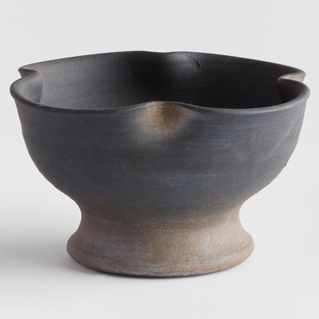 This footed bowl is hand thrown and formed by an artisans touch. But the real story is in the glaze. The dynamic texture...