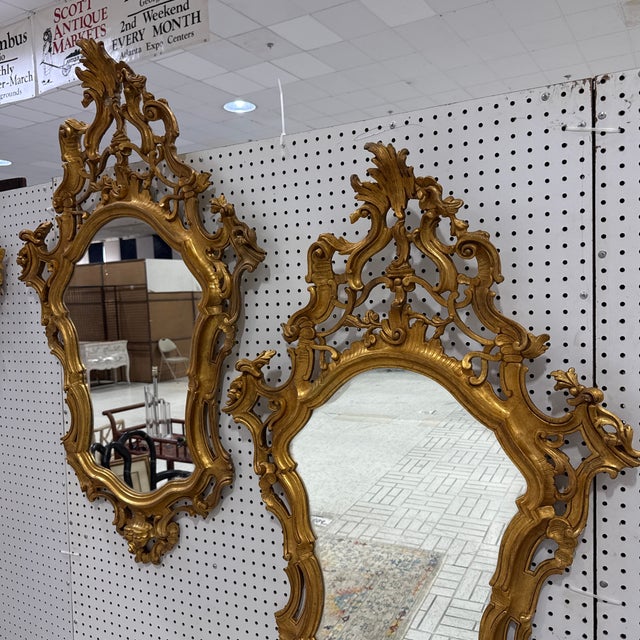 An exquisite pair of vintage mid-century Italian Rococo / Florentine-style wall mirrors. Crafted with dramatic openwork...