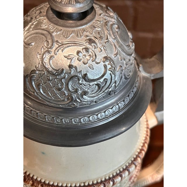 Impressive antique 17-inch German relief beer stein featuring the classic "Der Sonntagsjäger" (The Sunday Hunter) scene...
