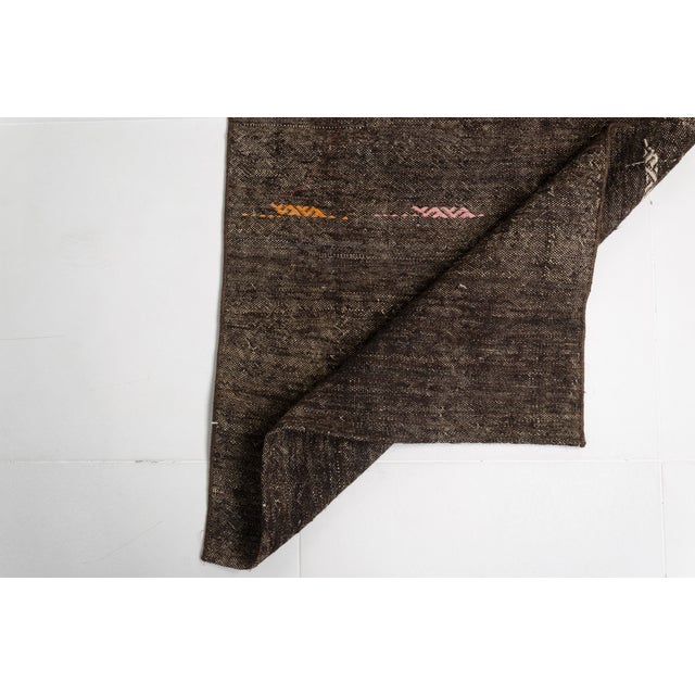 This is a vintage Turkish Oushak rug from the Mid 20th Century. The piece was hand-knotted.v