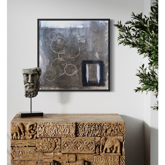 Triumphant by J. Kent Martin is a contemplative study in balance and stillness, rendered in layered grays, soft metallic...