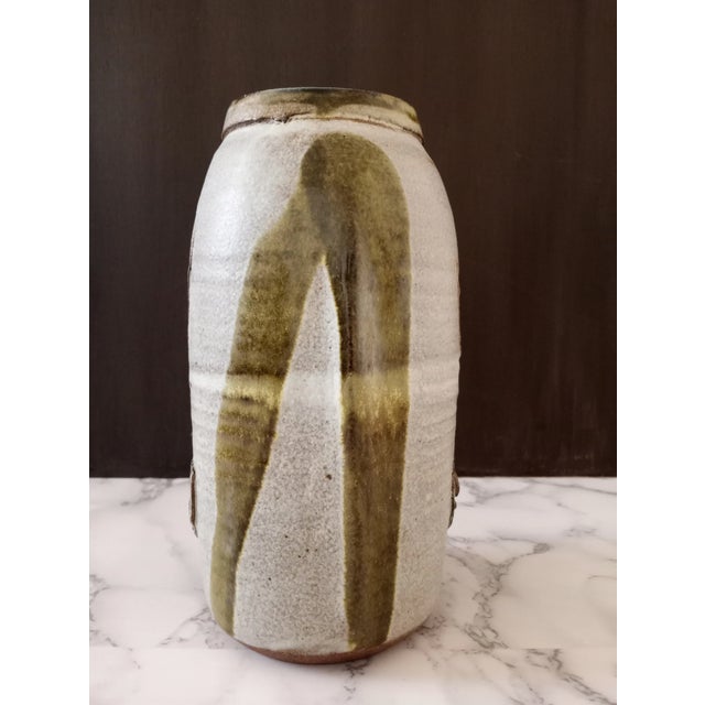 A substantial 9-inch hand-thrown studio pottery vessel by artist Nora, dating to the 1970s American studio craft movement....