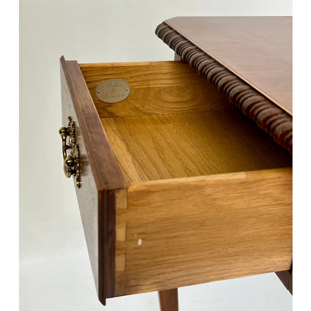 Beautiful Queen Anne style writing desk by Baker Furniture. Features a beautifully figured book-matched walnut top banded...