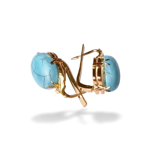 Timeless pair of solid 14kt yellow gold pierced earrings featuring substantial natural turquoise cabochons. Each earring...