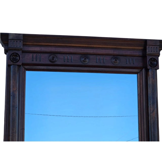 This 19th Century American Victorian Walnut Pierre Mirror is a beautifully crafted hallway mirror from the Victorian era....