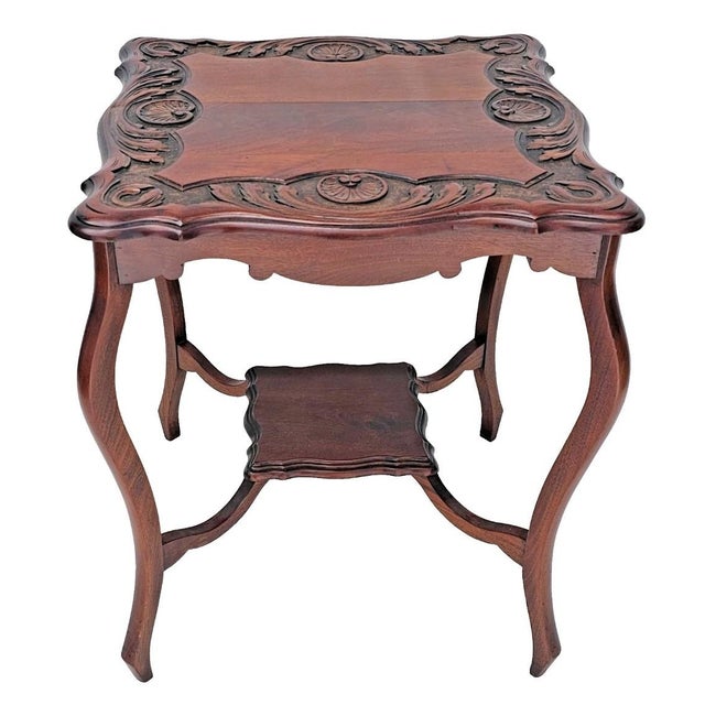 This antique English Rococo Revival mahogany lamp table dates to around 1890 and showcases the elegance and craftsmanship...