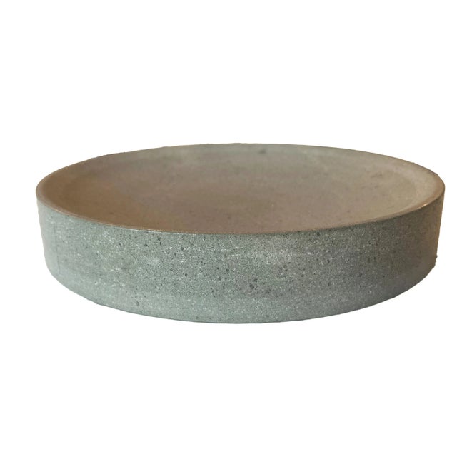 An artesian concrete bowl/plate, a masterpiece of design that marries form with function. Crafted from solid concrete,...