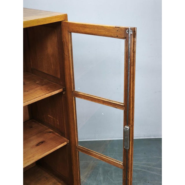 A rare oak and glass bookcase or display cabinet dating from the 1930s, originating from a former Baťa factory in...