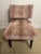 An upholstered vintage tiger print slipper chair. It has a striking red and cream pattern in velvet. This armless chair...