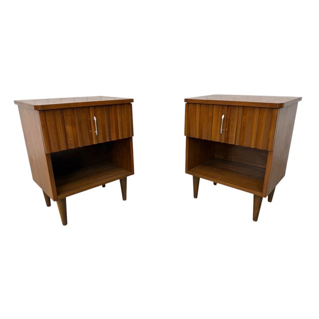 Elevate your bedroom with this striking pair of Mid-Century Modern walnut nightstands by Young Manufacturing. Showcasing...