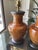 A sophisticated pair of Visual Comfort ceramic table lamps featuring richly glazed caramel-hued urn-form bodies accented...