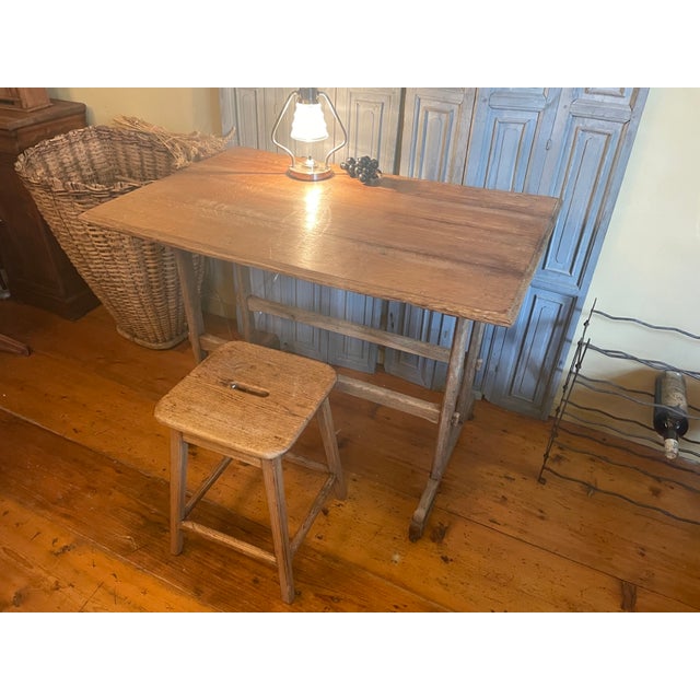 A stunning antique table from France, transparent and playful. Made of oak, it stands on casters. You can simply sit at...