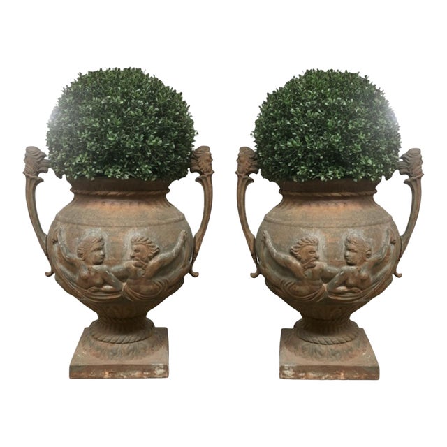 Pair of English Cast Iron Urn Planters With Figural Reliefs For Sale