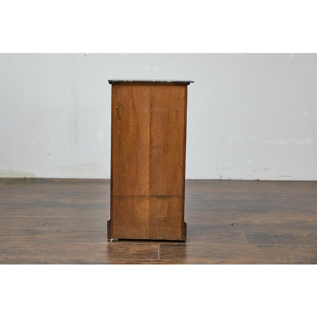 A French Turn of the Century walnut small cabinet from circa 1900 with grey variegated marble top, single drawer over...