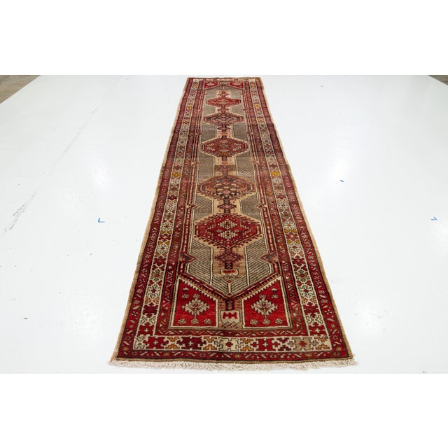This beautiful 20th-century Persian Serab Handmade wool rug has a beige and red field with multicolor accents throughout...