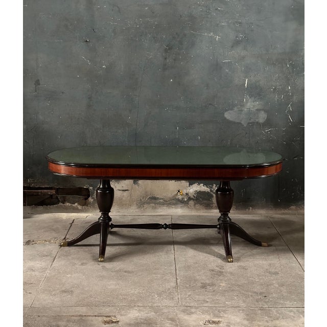 A remarkable mid 20th century Italian dining table designed by Vittorio Dassi. Oval shaped surface featuring reverse...