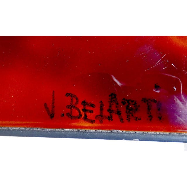 Large mid-century table featuring ceramic tiles supported by a chrome frame. The tiles were produced in flamed hues...