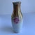 This German made vase, in the style of Lusterware, are pink rose buds in a chestnut brown background.