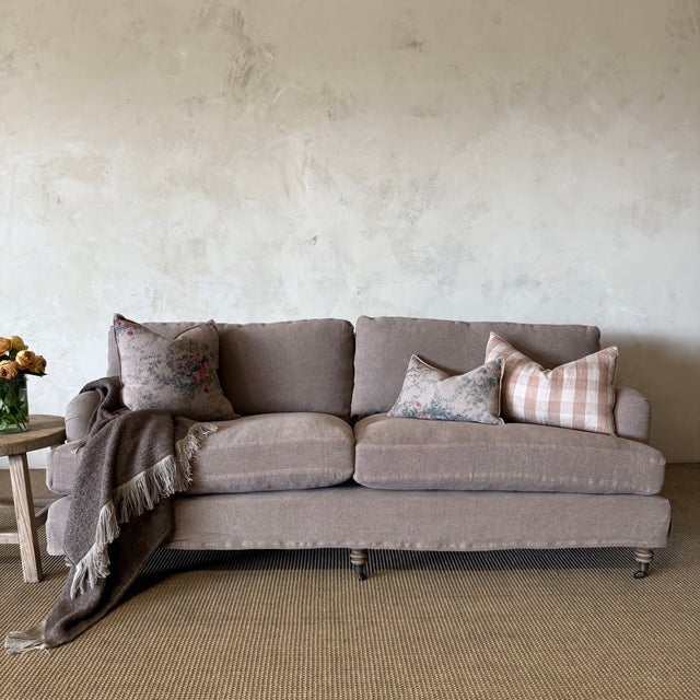 Relaxed elegance meets everyday comfort in the Marion Linen Slipcovered Sofa. Upholstered in a warm linen with soft plum...