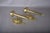 Pair of solid brass wall sconces with straight torch-form stems, ornate round backplates and pineapple finials. Fluted...