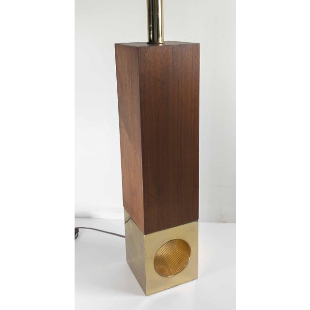 We are selling this simple and elegant Mid-Century modern lamp. This lampe has simple rectangular wlanut block situated...