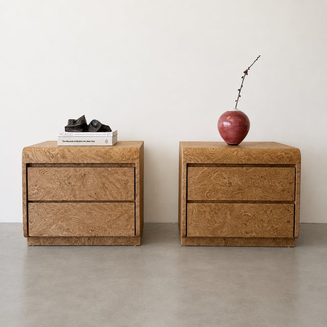 A striking pair of vintage 1970s Mid-Century Modern nightstands featuring richly figured walnut burlwood with beautiful...