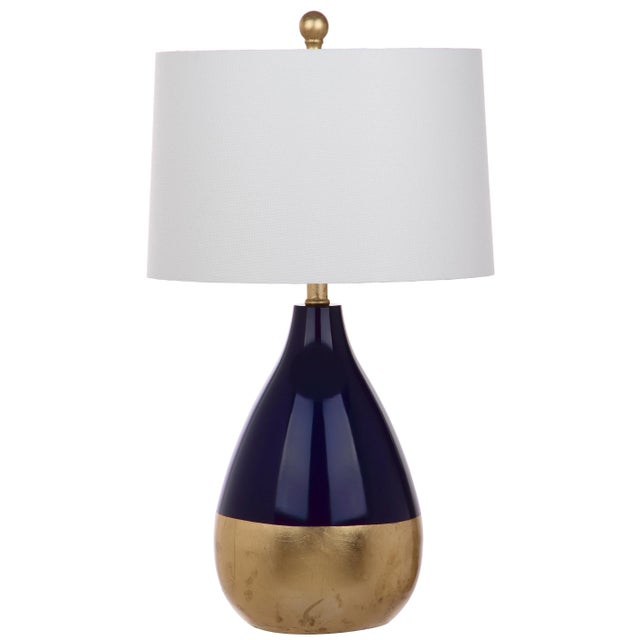 The decadent décor of a London’s designer’s lush home inspired this set of 24-inch navy and gold table lamps. Place on...